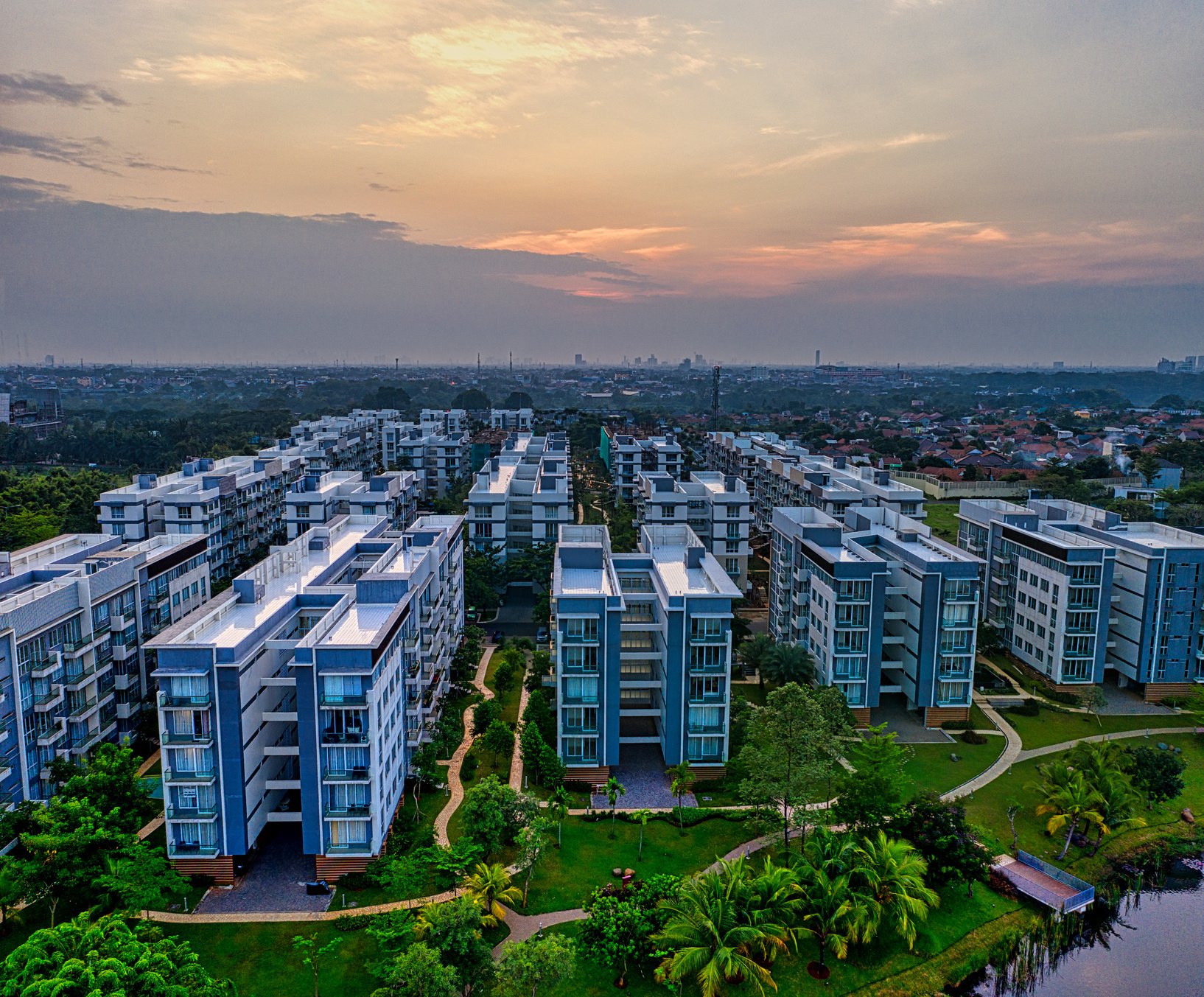 Cityscape with residential buildings on coast at sundown